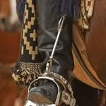 Handmade silver stirrup paired with a traditional gaucho boot, showcasing Argentina's craftsmanship. Traditional Argentine Crafts