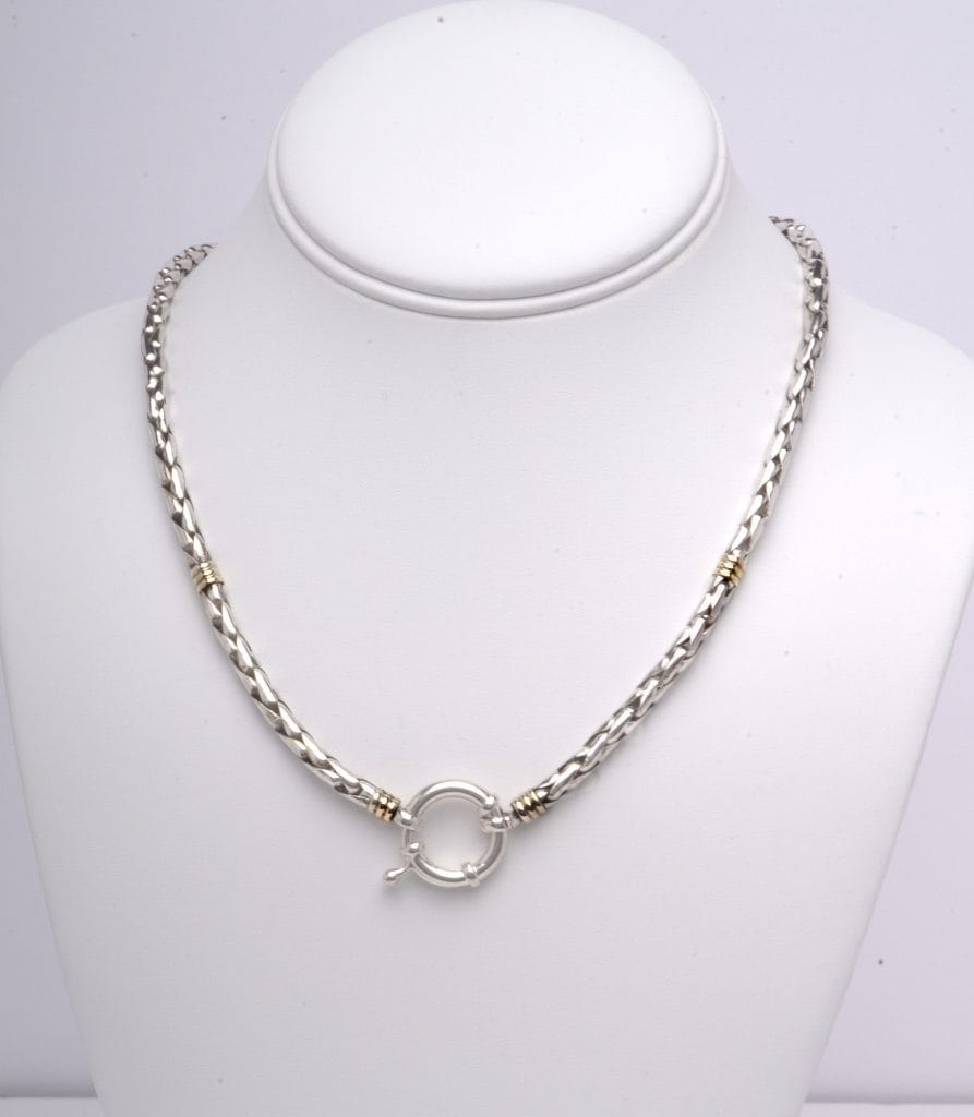 Silver and gold braided necklace with heavy ring.