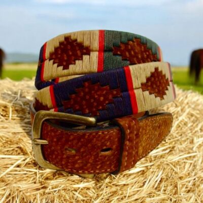 Hand-stitched Carpincho leather polo belt with a solid brass buckle, featuring red, green, navy blue, taupe, and red stripe embroidery.