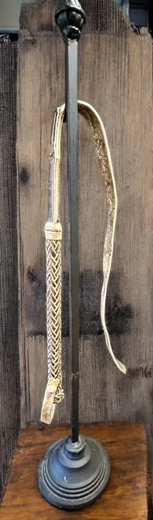 Braided leather riding crop.