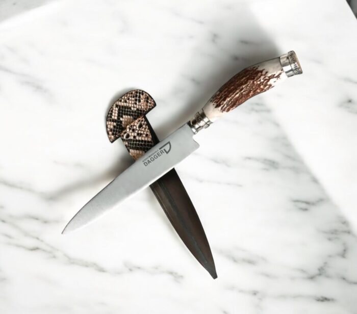 Handcrafted stainless steel staghorn knife with alpaca silver detailing and chocolate leather sheath featuring snake skin accents.