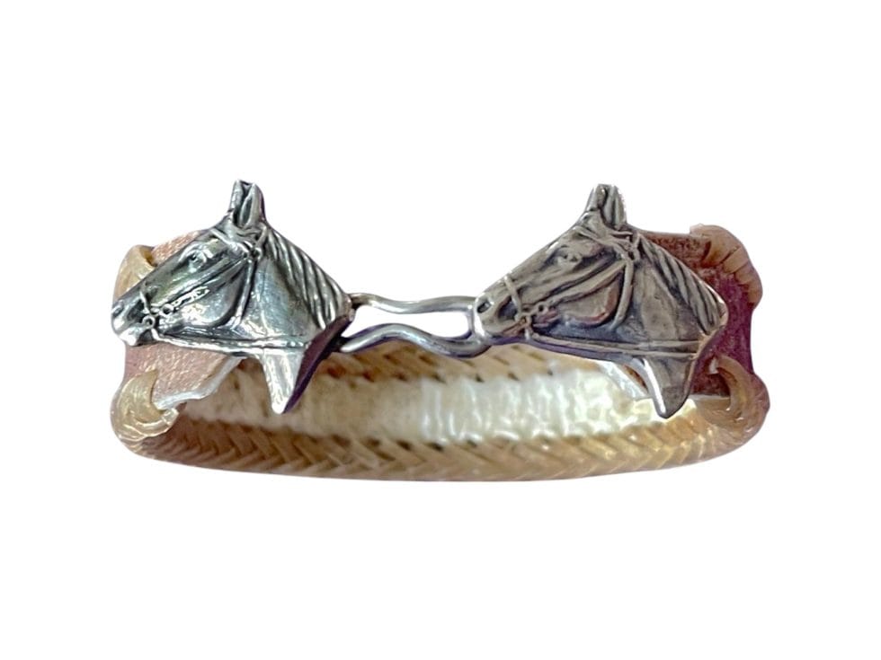 Hand braided leather bracelet with two silver horse heads.
