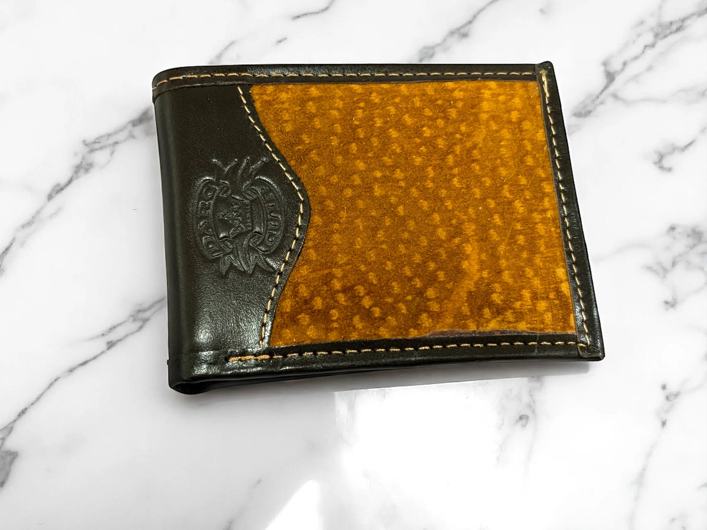 Chocolate cowhide-trimmed carpincho bifold wallet closed.