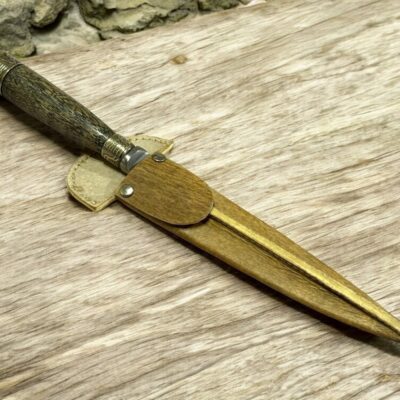 Handmade Gaucho knife with wooden handle, alpaca details, and rawhide sheath