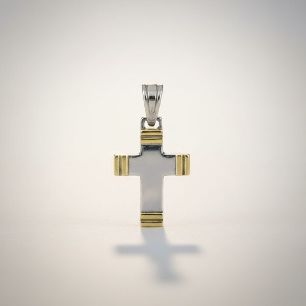 Classic cross pendant in sterling silver with gold accents close-up