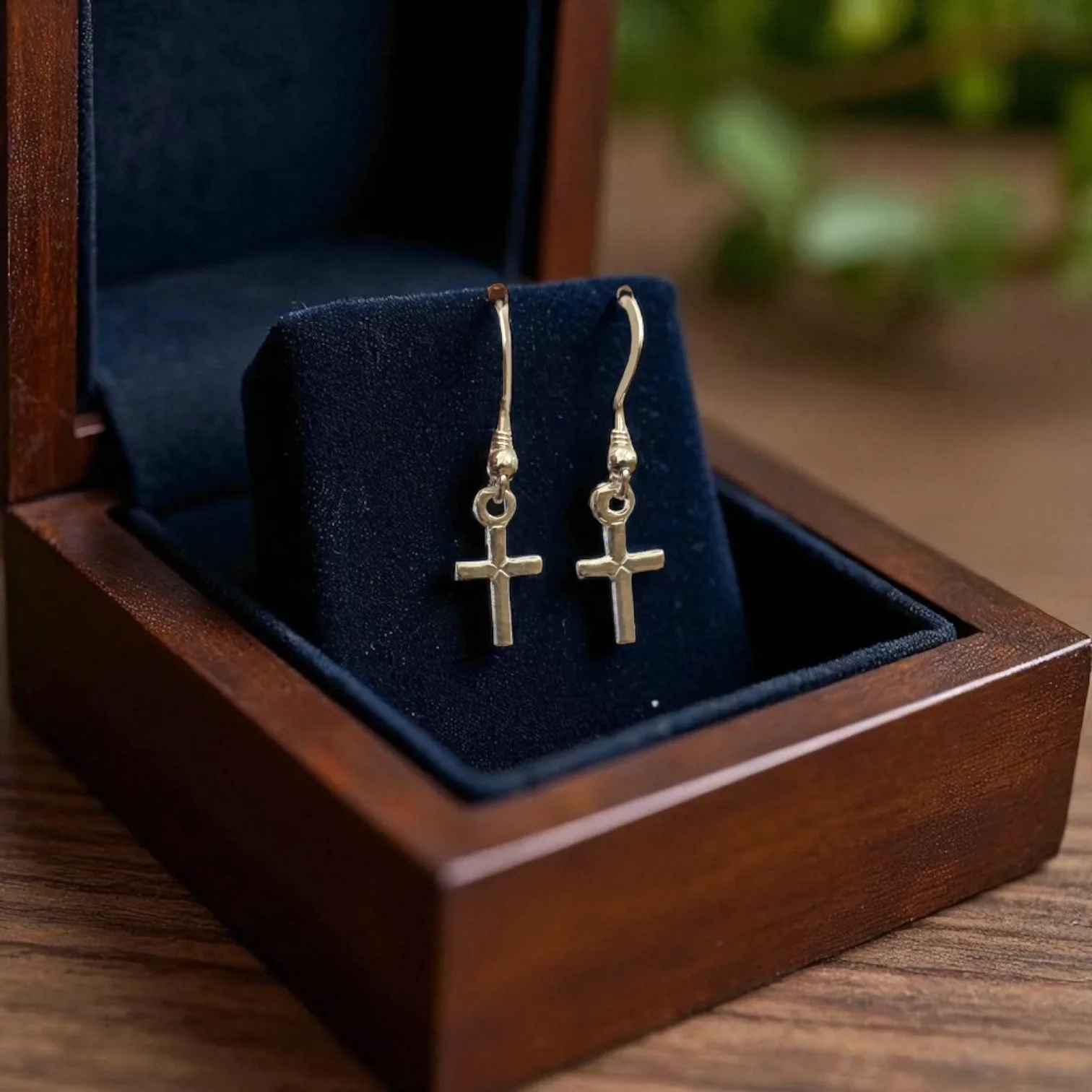 925 silver cross earrings displayed inside a polished wooden box with black velvet lining