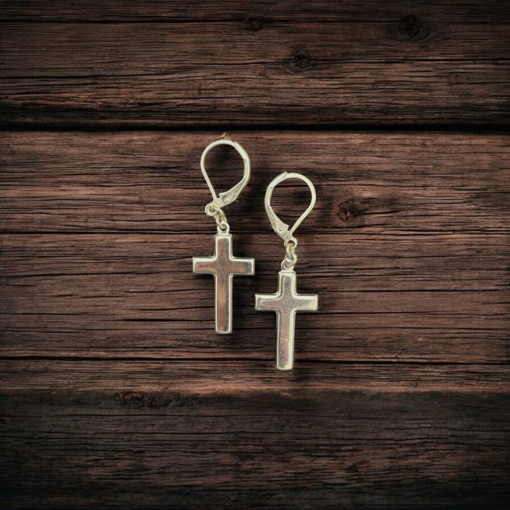 Close-up photo of sterling silver cross dangle earrings showing fine craftsmanship and shine