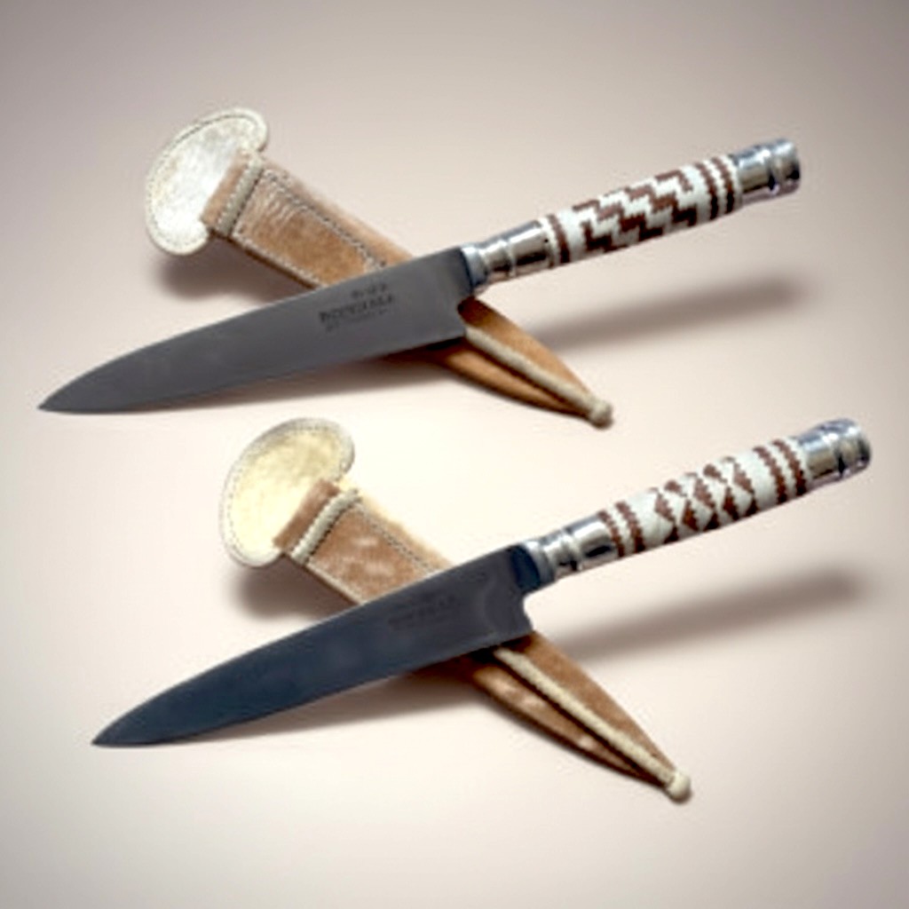 Hande forge gaucho knife with polished steel blade and rawhide braided handle