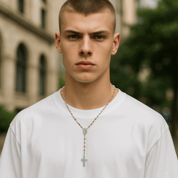 Male model wearing a sterling silver rosary with rose gold and yellow gold-plated beads as a necklace