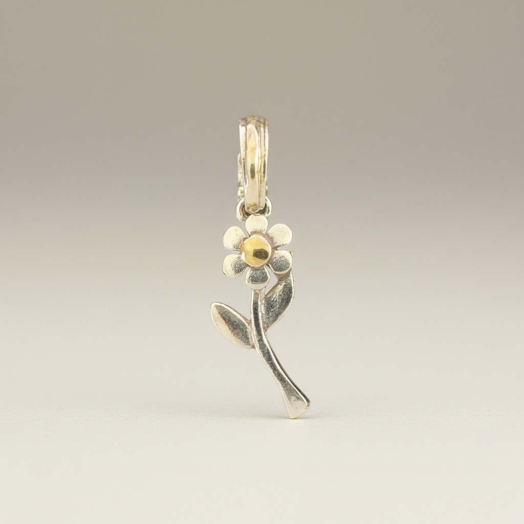 Sterling silver flower pendant with stem and leaves, yellow gold center and bail