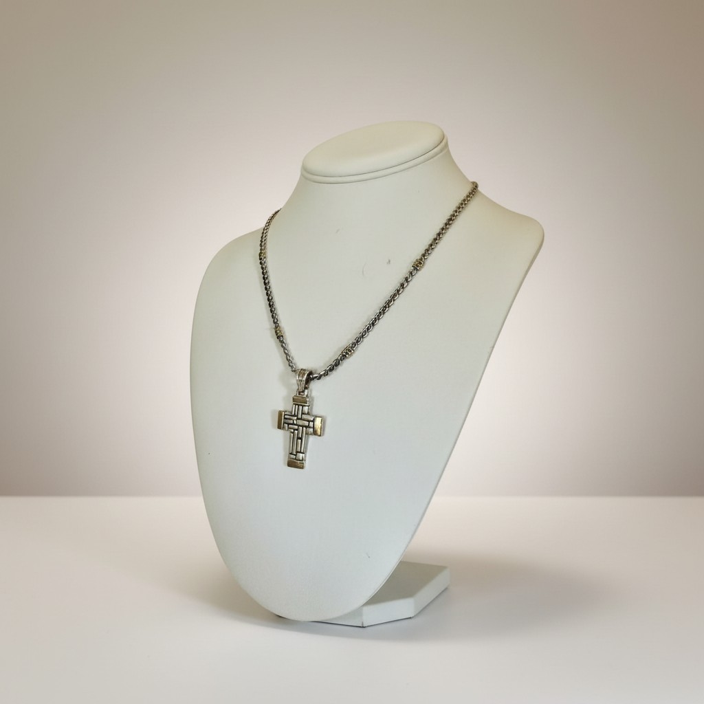 Cross pendant on chain displayed on jewelry stand