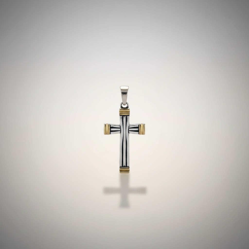 Cross pendant in sterling silver with gold accents on a clean background