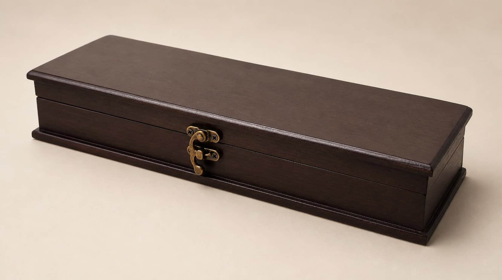 Dark wooden knife presentation box closed with antique brass clasp