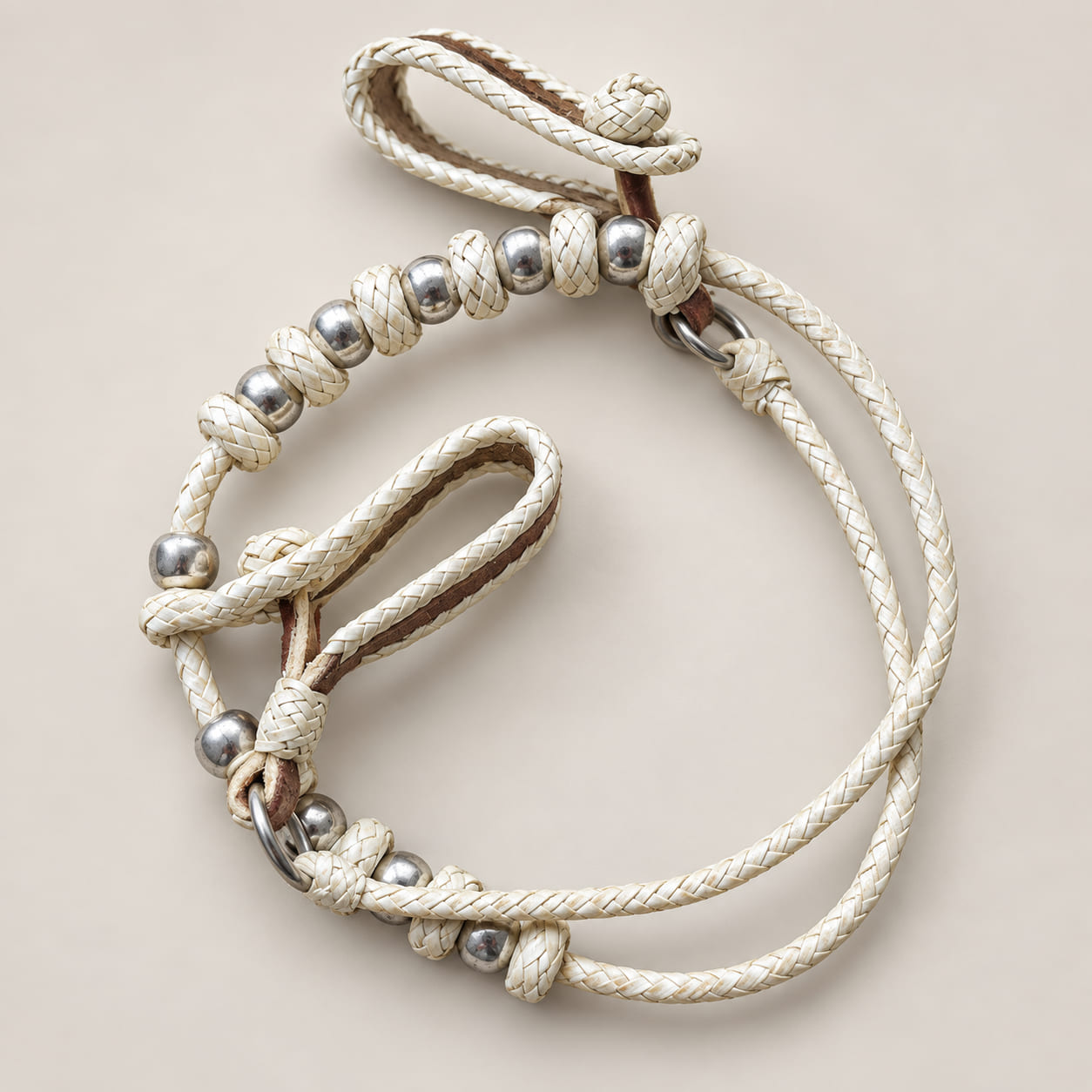 Hand-braided Argentine rawhide horse halter with silver-tone beads and traditional loop closures