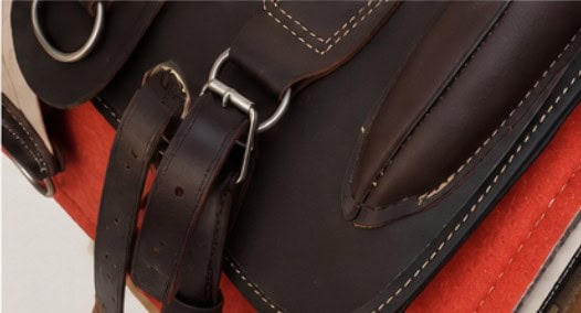 Close-up of leather straps and handcrafted details on an Argentine Recado Criollo saddle