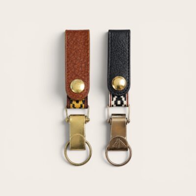 Handmade capybara and black leather keychains with traditional Guarda Pampa detail and solid brass hardware.