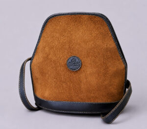 Front view of a handmade capybara leather backpack crafted in Argentina with premium cowhide leather trim.