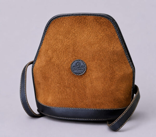 Front view of a handmade capybara leather backpack crafted in Argentina with premium cowhide leather trim.