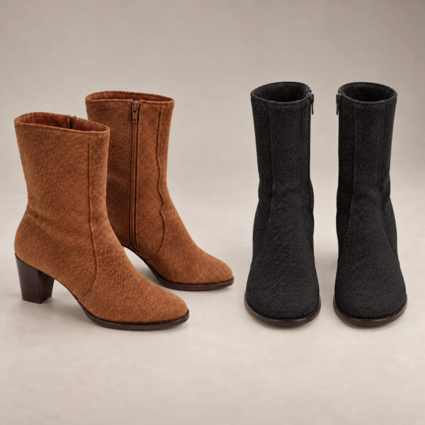 Two pairs of capybara leather boots in tan and black, with mid-height shafts, curved seams, side zippers and block heels.