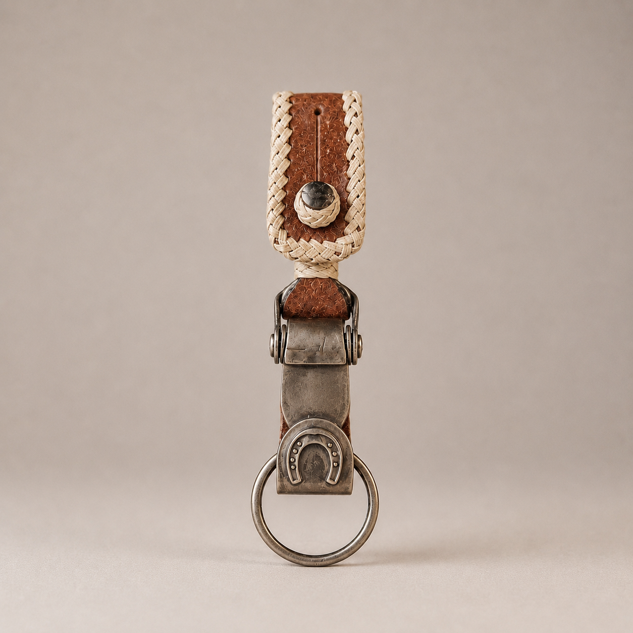 Argentine capybara leather keychain with horseshoe motif and hand-braided rawhide detail