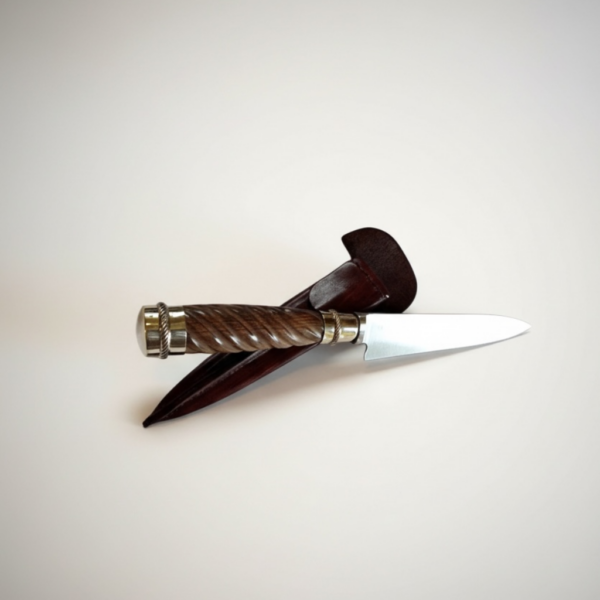 Handmade gaucho knife crossed over chocolate brown leather sheath
