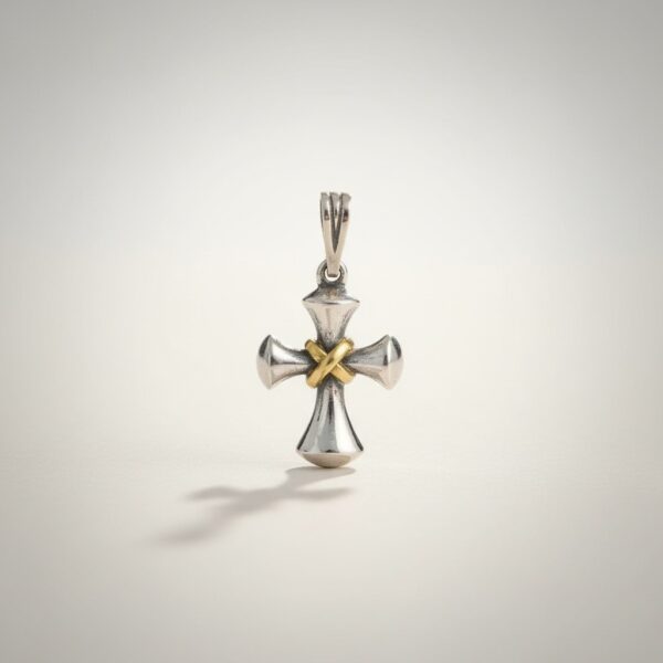 Love knot cross pendant in sterling silver with gold center close-up