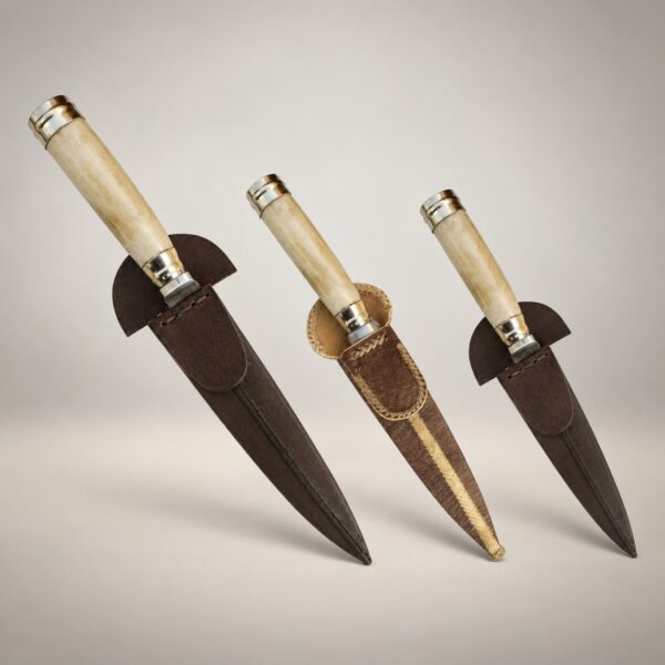 Three natural bone handle gaucho knives with alpaca silver fittings and rawhide and chocolate brown leather sheaths