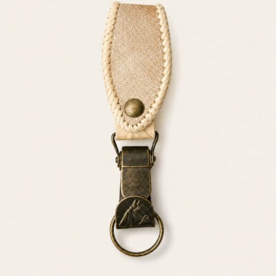Handmade Argentine rawhide leather keyring featuring a clip style brass fitting and hand-stitched rawhide belt loop