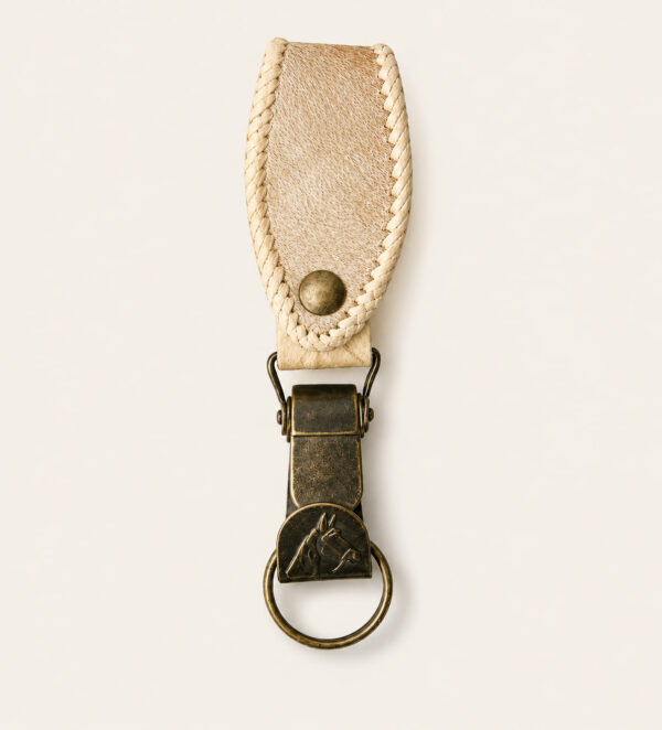 Handmade Argentine rawhide leather keyring featuring a clip style brass fitting and hand-stitched rawhide belt loop