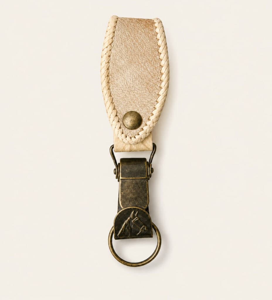Handmade Argentine rawhide leather keyring featuring a clip style brass fitting and hand-stitched rawhide belt loop