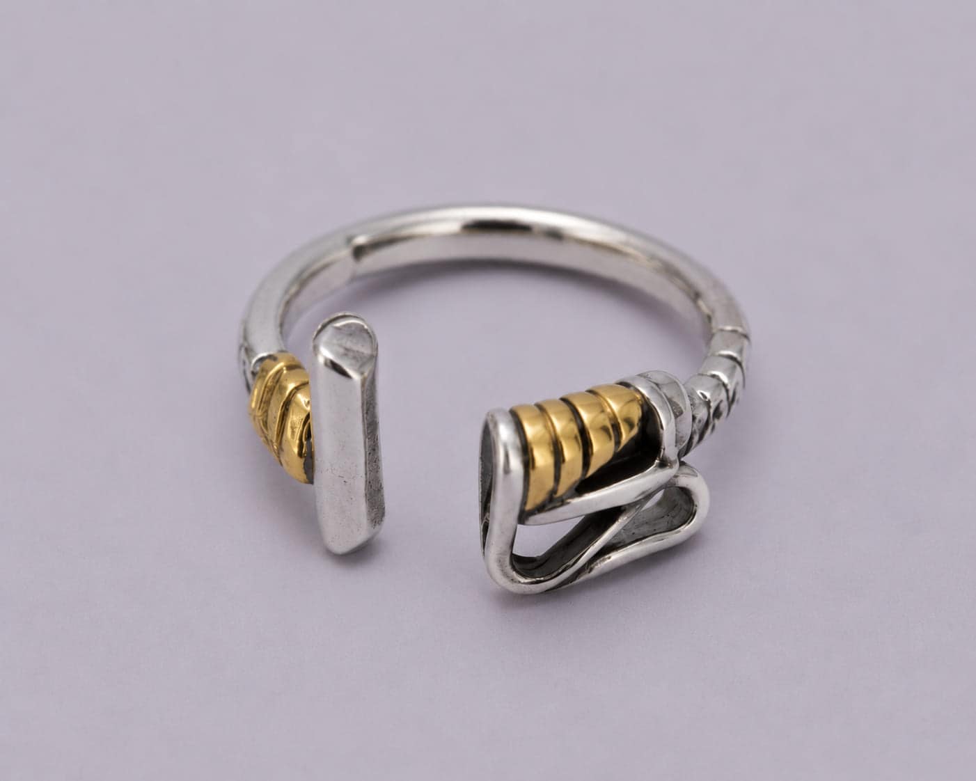 Handcrafted .925 sterling silver Polo Mallet wrap ring with 18kt gold accents and an adjustable open design.