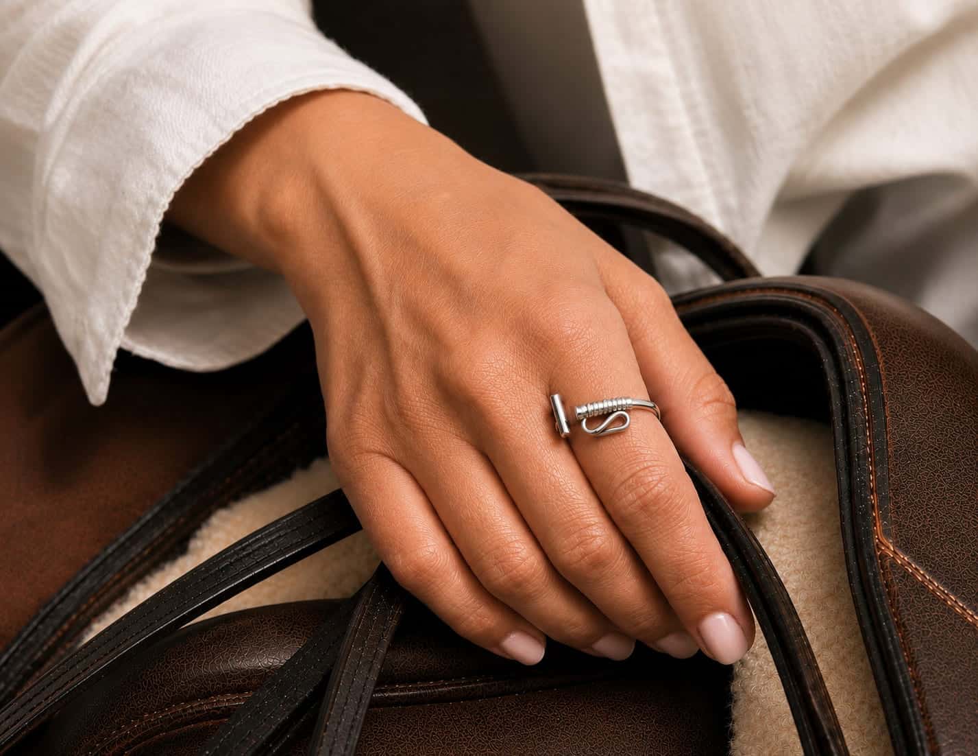 Handcrafted sterling silver Polo Mallet wrap ring worn on the hand, showcasing the sculptural adjustable design inspired by Argentina's polo heritage.
