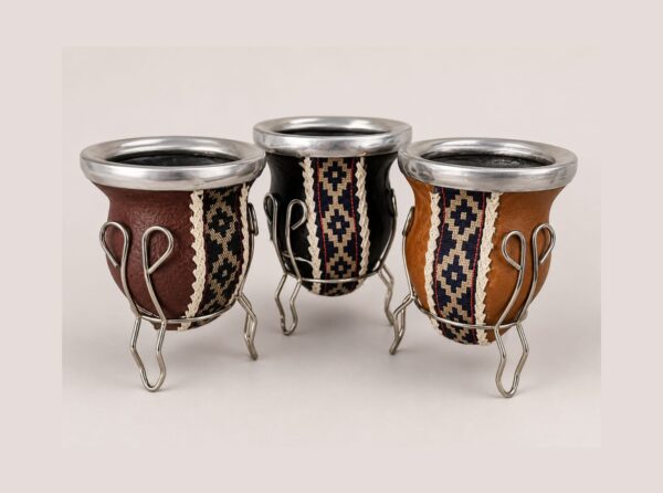 Traditional Argentine mate gourds with matching stands, handcrafted in genuine leather with alpaca silver rims and classic Guarda Pampa ribbon.