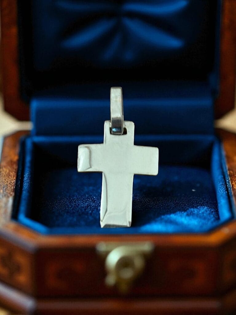 Small 925 sterling silver cross pendant on a gift box
