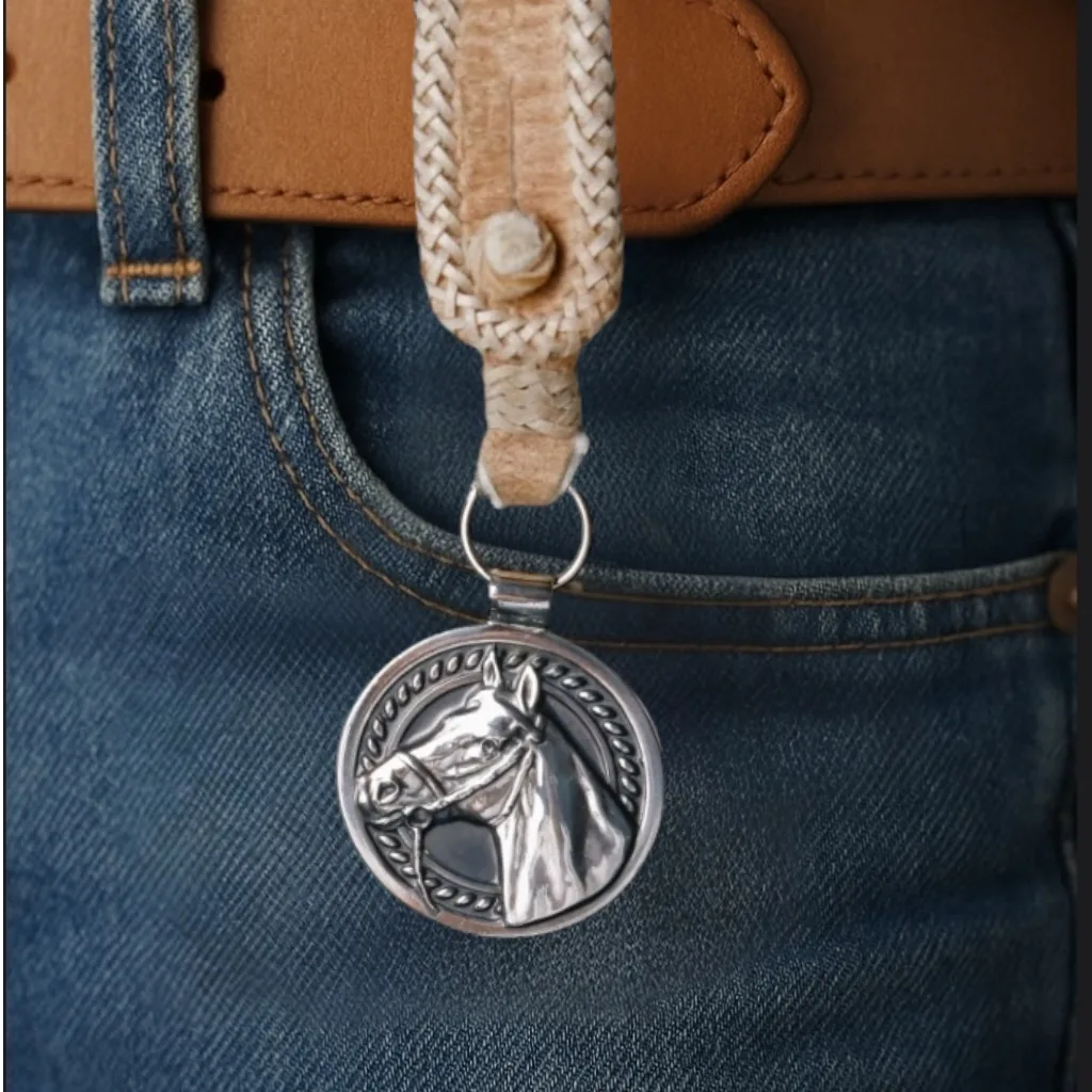 The 925 Silver Plated Alpaca Horse Head Keychain with Rawhide Leather Loop worn on a jeans belt.