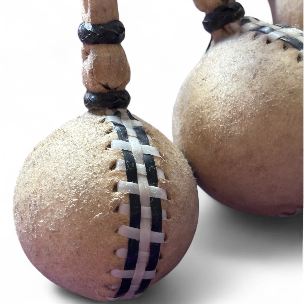 Close-up view of gaucho boleadoras with braided rawhide cords.