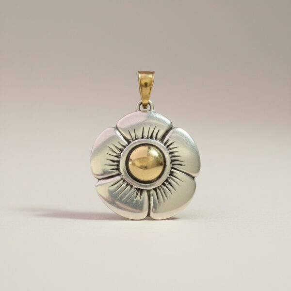 Pansy flower pendant crafted in sterling silver with yellow gold details on a clean background