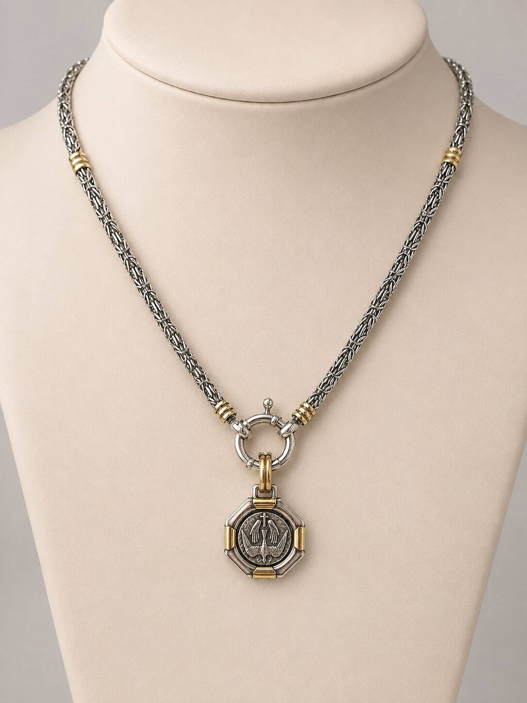 Holy Spirit pendant in sterling silver with Dublee gold accents displayed on a silver and gold necklace.
