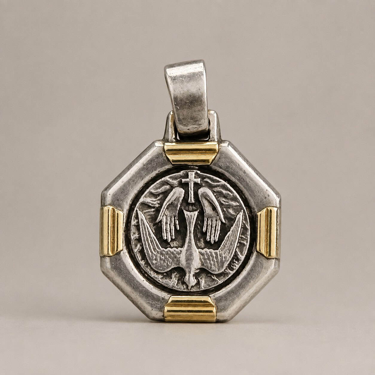 Holy Spirit sterling silver pendant handcrafted in Argentina with genuine Dublee gold accents and hand-applied patina.